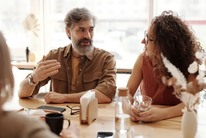 An agent talking through a report with clients at a table