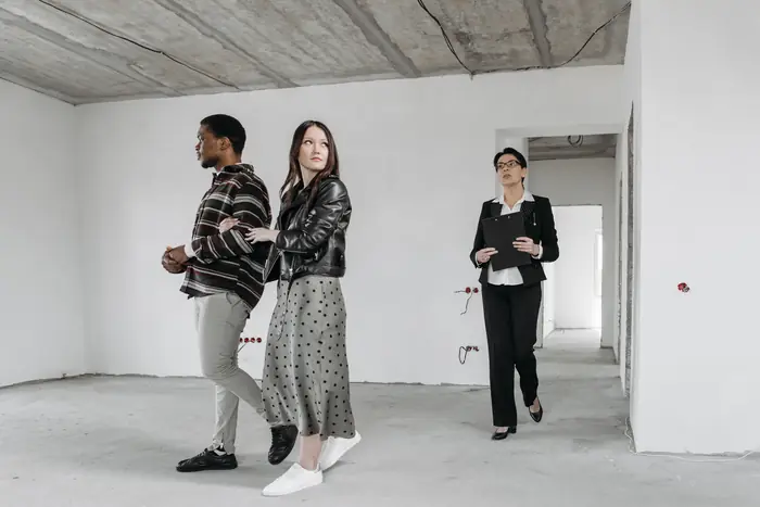 A couple touring a new home with their agent